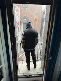 Husband enjoying the view from the balcony of our hotel.