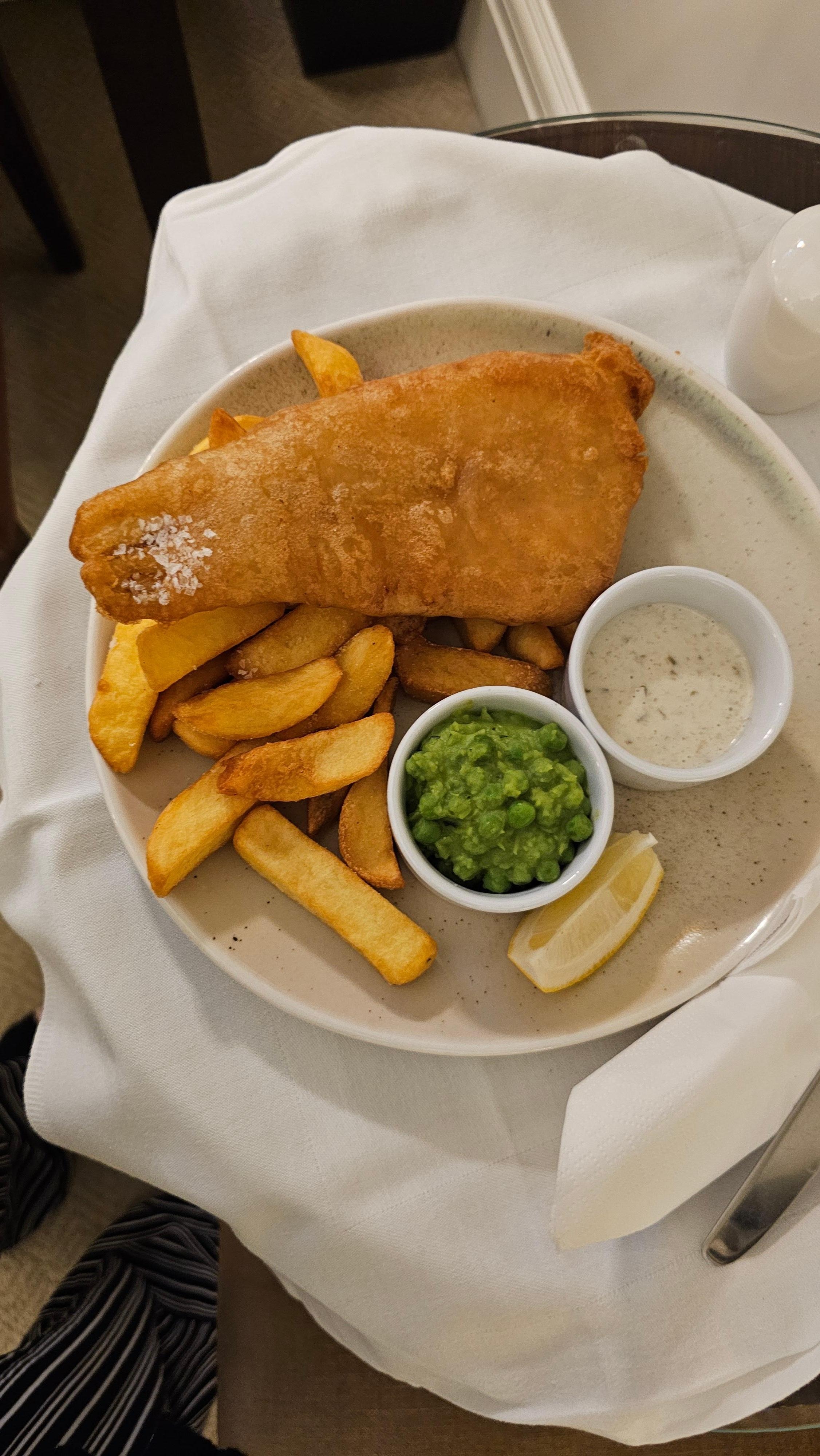 Battered fish, chips and mushy peas.