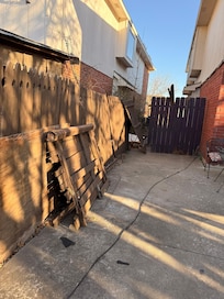 Broken fence laying in backyard