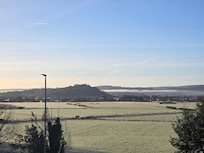A room with a view on a bright morning with low lying mist.