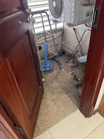 Utility room with broken door that wouldn't shut.