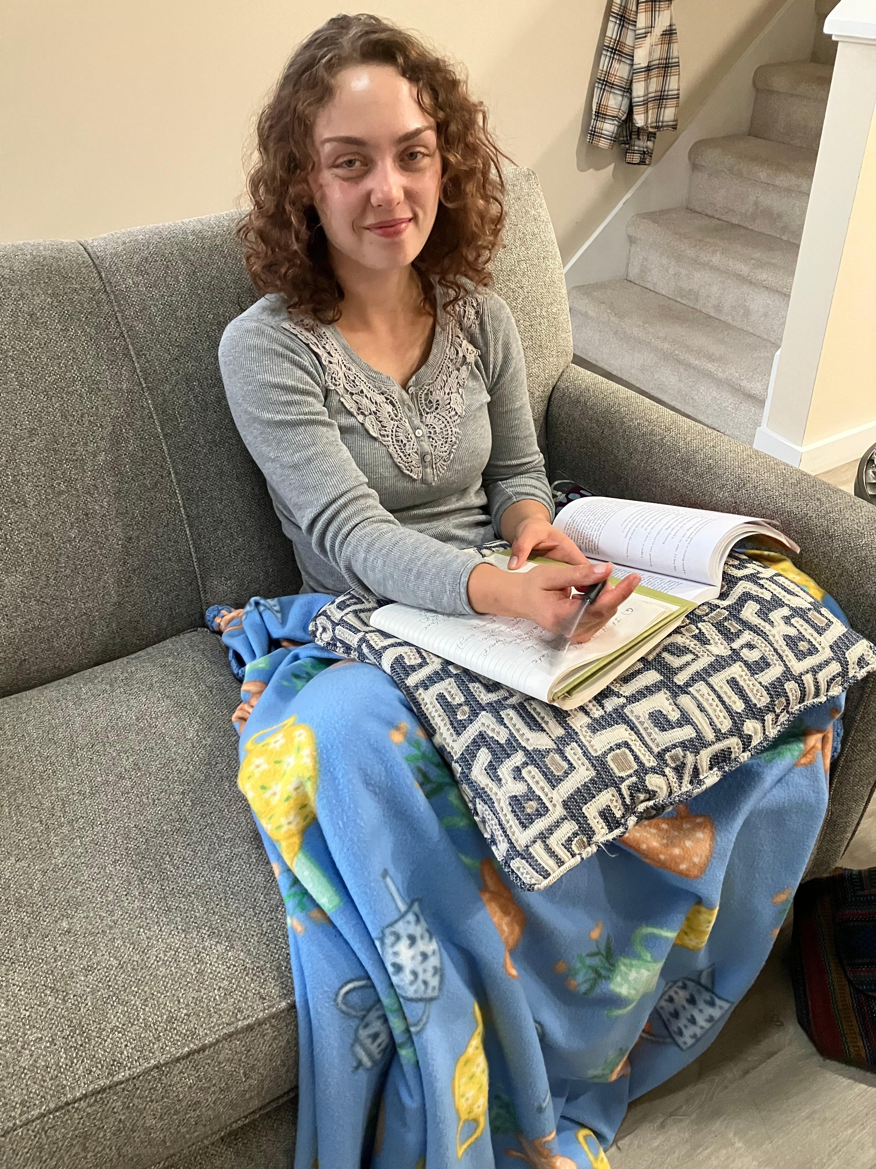 Our Granddaughter relaxing with a book.