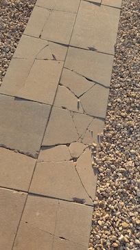 Walkway to pool was not installed properly, creating sharp and loose cement.