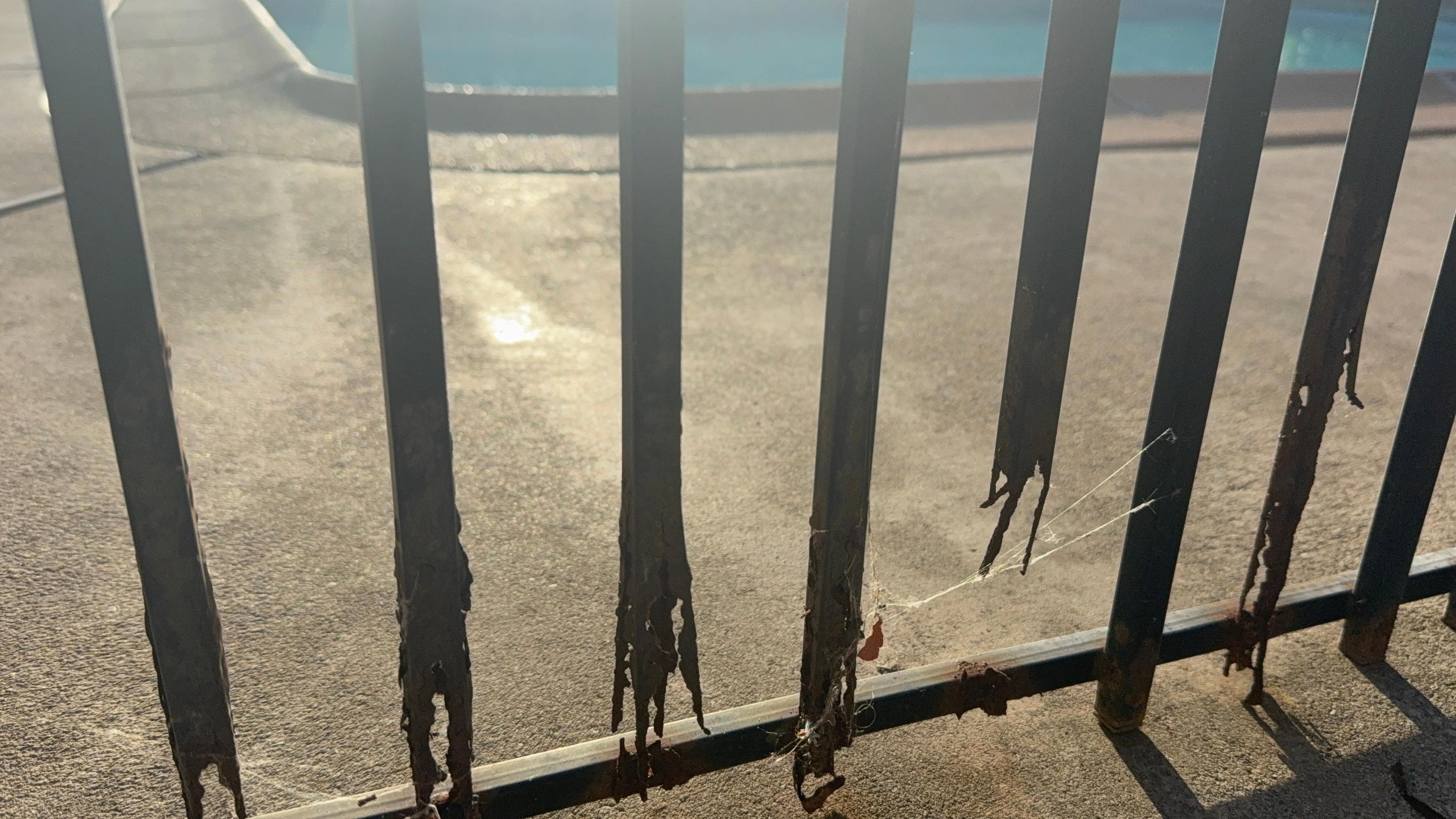 Rusted fence around pool