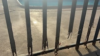 Rusted fence around pool