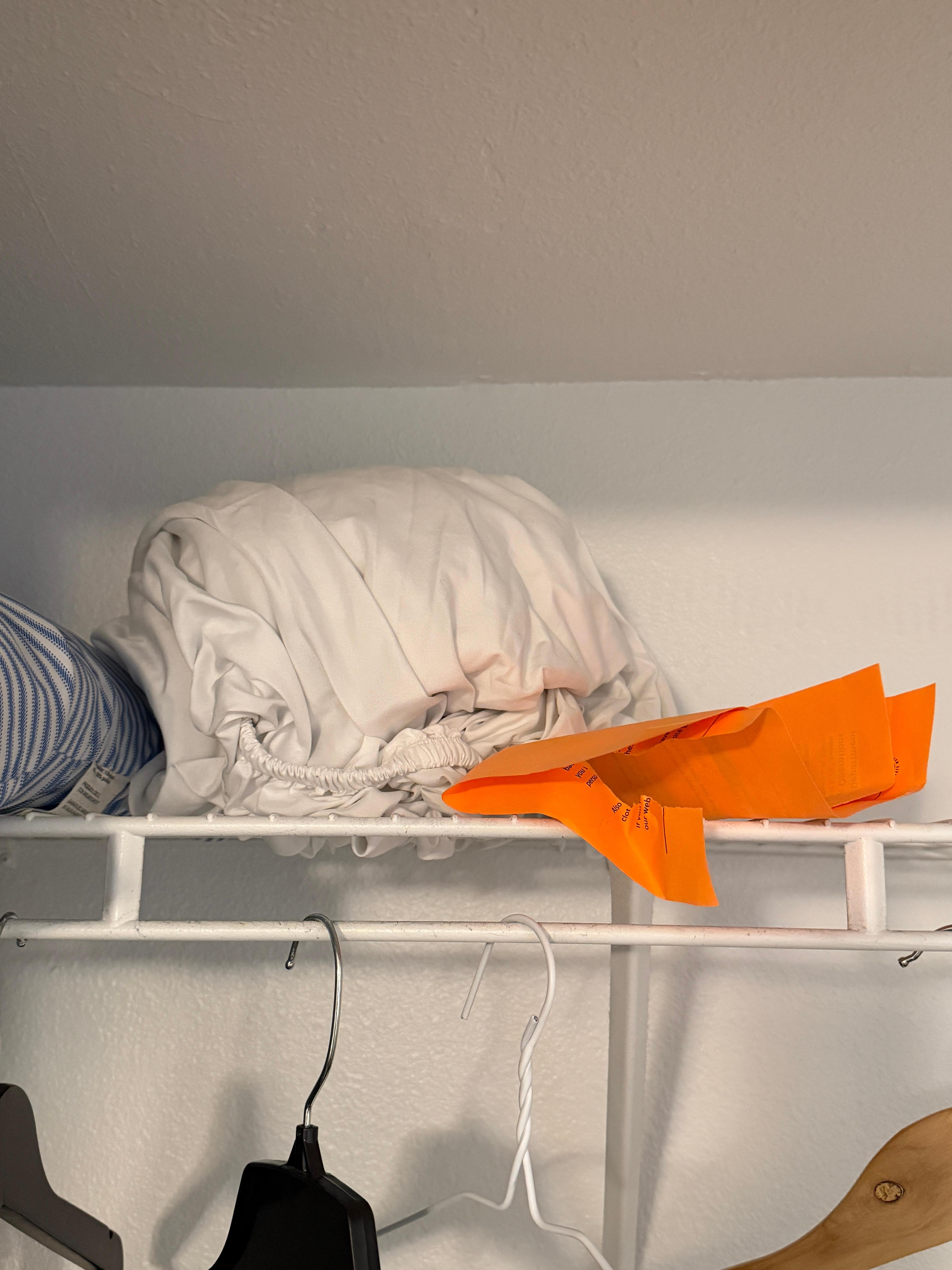 trash in closet/balled up linens