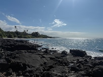 Day time photo of the beach steps from the house