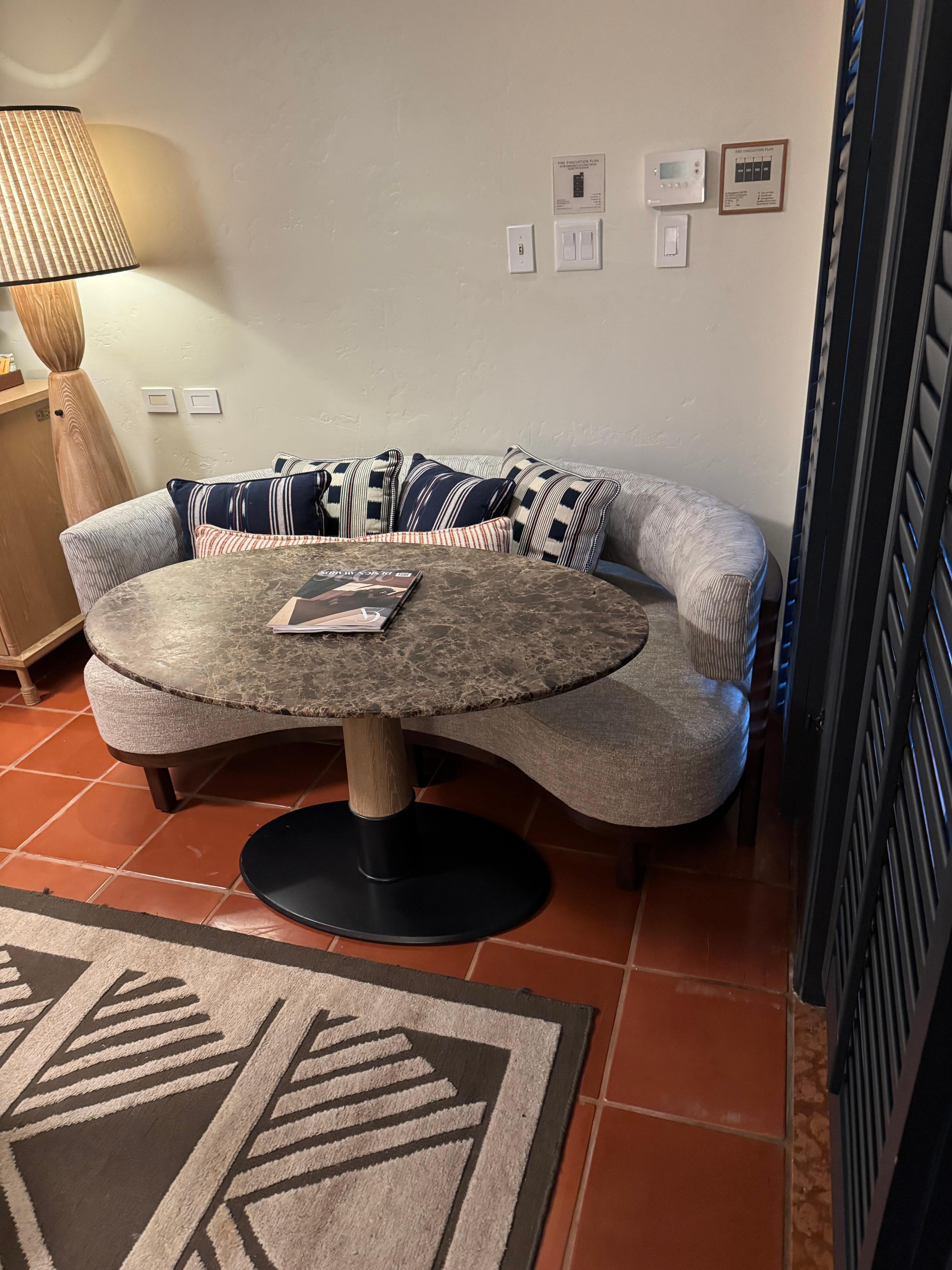 Table and couch poorly placed, table bumps into rug and on top of rug it is unstable. 