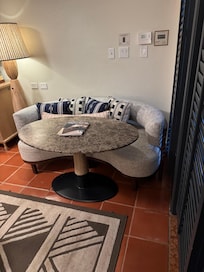 Table and couch poorly placed, table bumps into rug and on top of rug it is unstable.