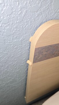 Chewing gum on the side of bed.