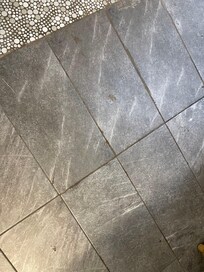 Floors had this dirt or filth all over them. Needed a good scrub with liquid cleaner not jump broom cleaned