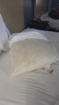 Yellow stains on pillows also room smells like stale cigarettes we requested two non smoking rooms