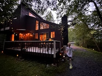 A picture of the house from the barbecue/fire pit area at night