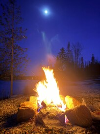 Fire pit in the yard looking at the lake.