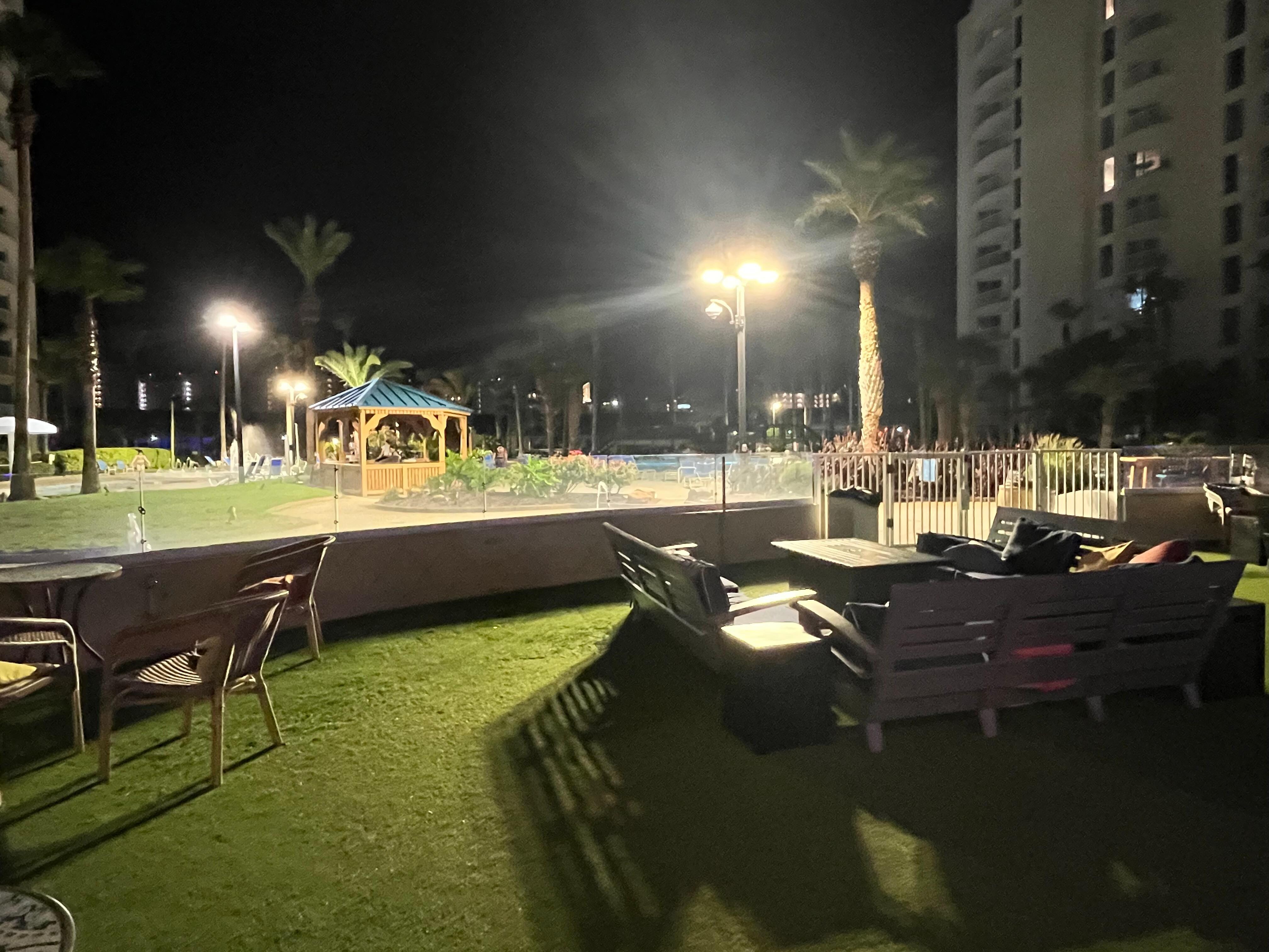 Nighttime on premises around pool, bistro area