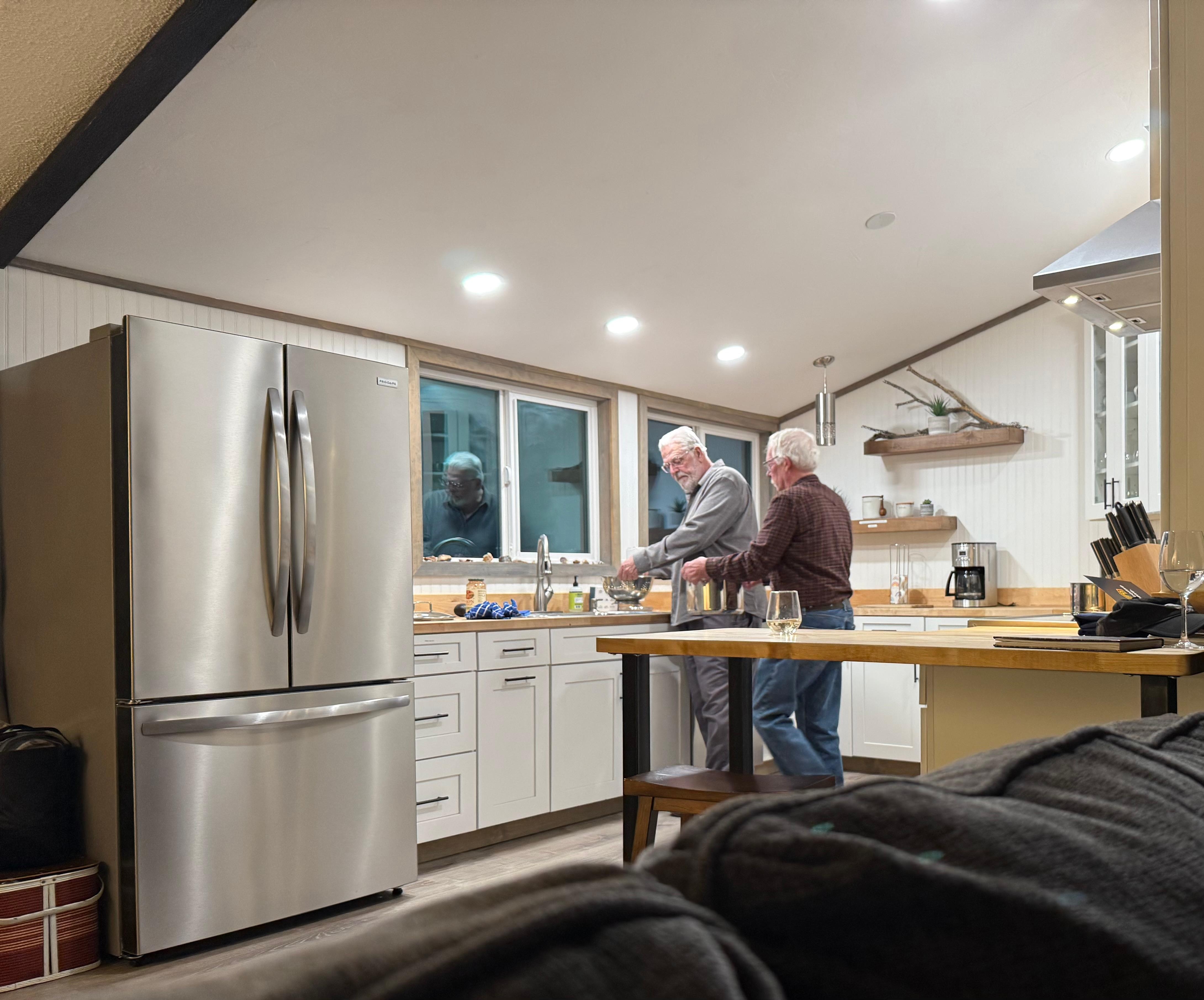 Our guys cooking dinner for us in the spacious kitchen while we relaxed in the living room