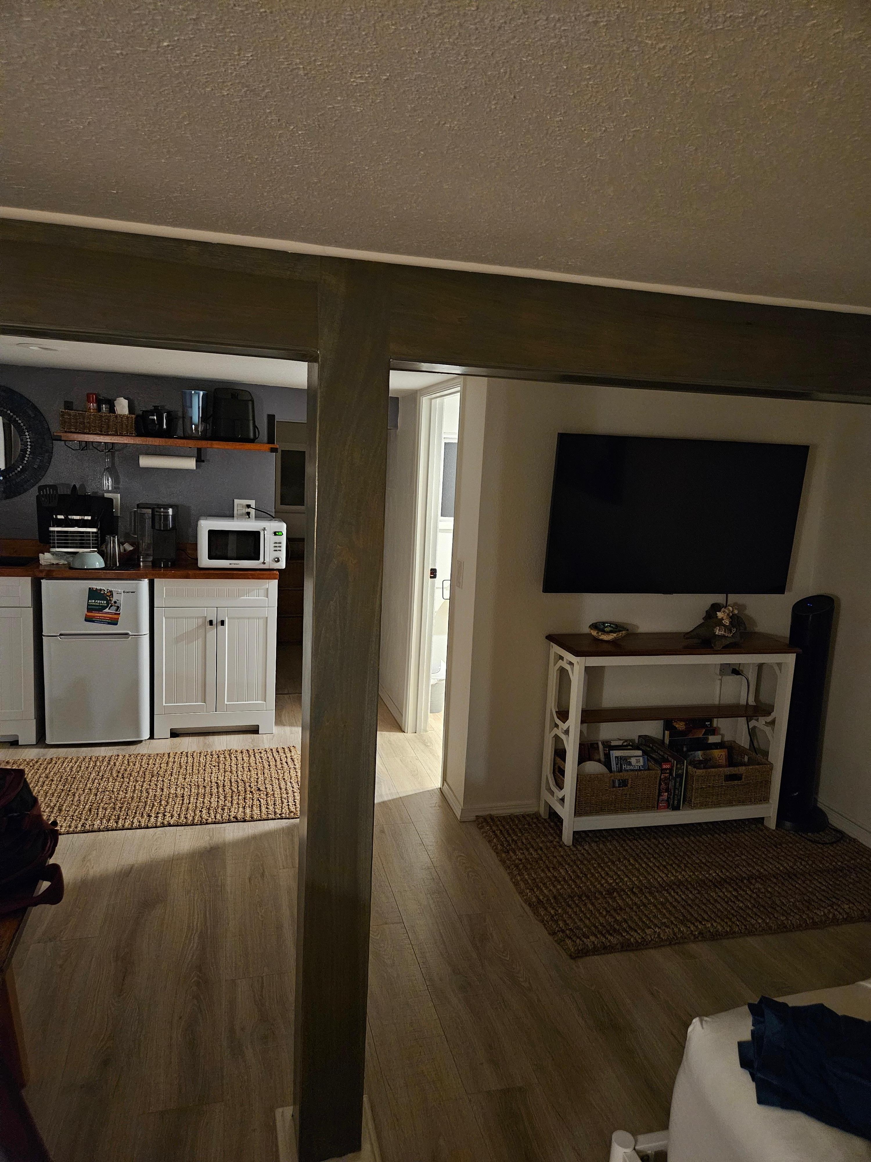 Post in the middle of the room with a beam that drops down from an already low ceiling.