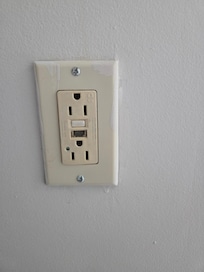 Broken electrical outlets and covers, and a GFCI with the buttons damaged.
