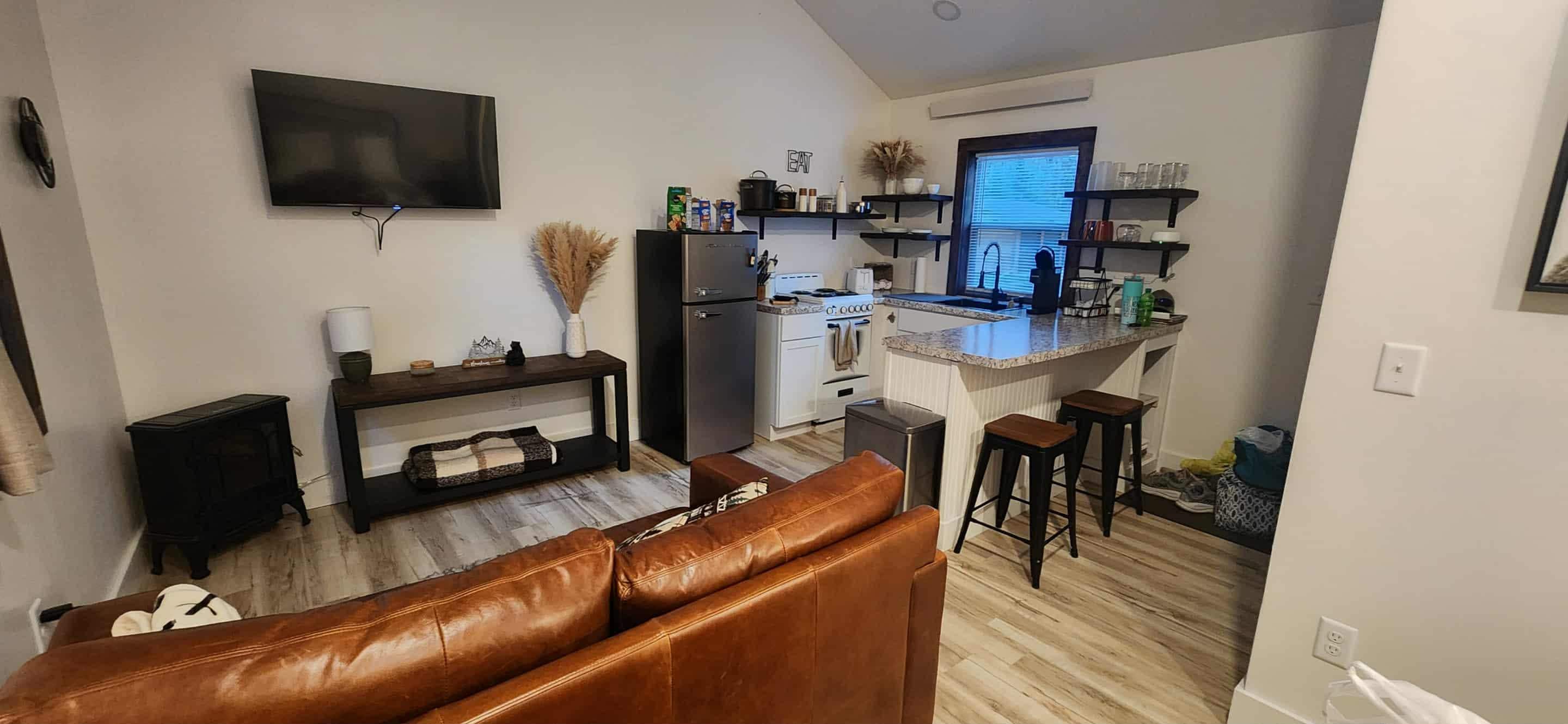 Living room with kitchen in the background