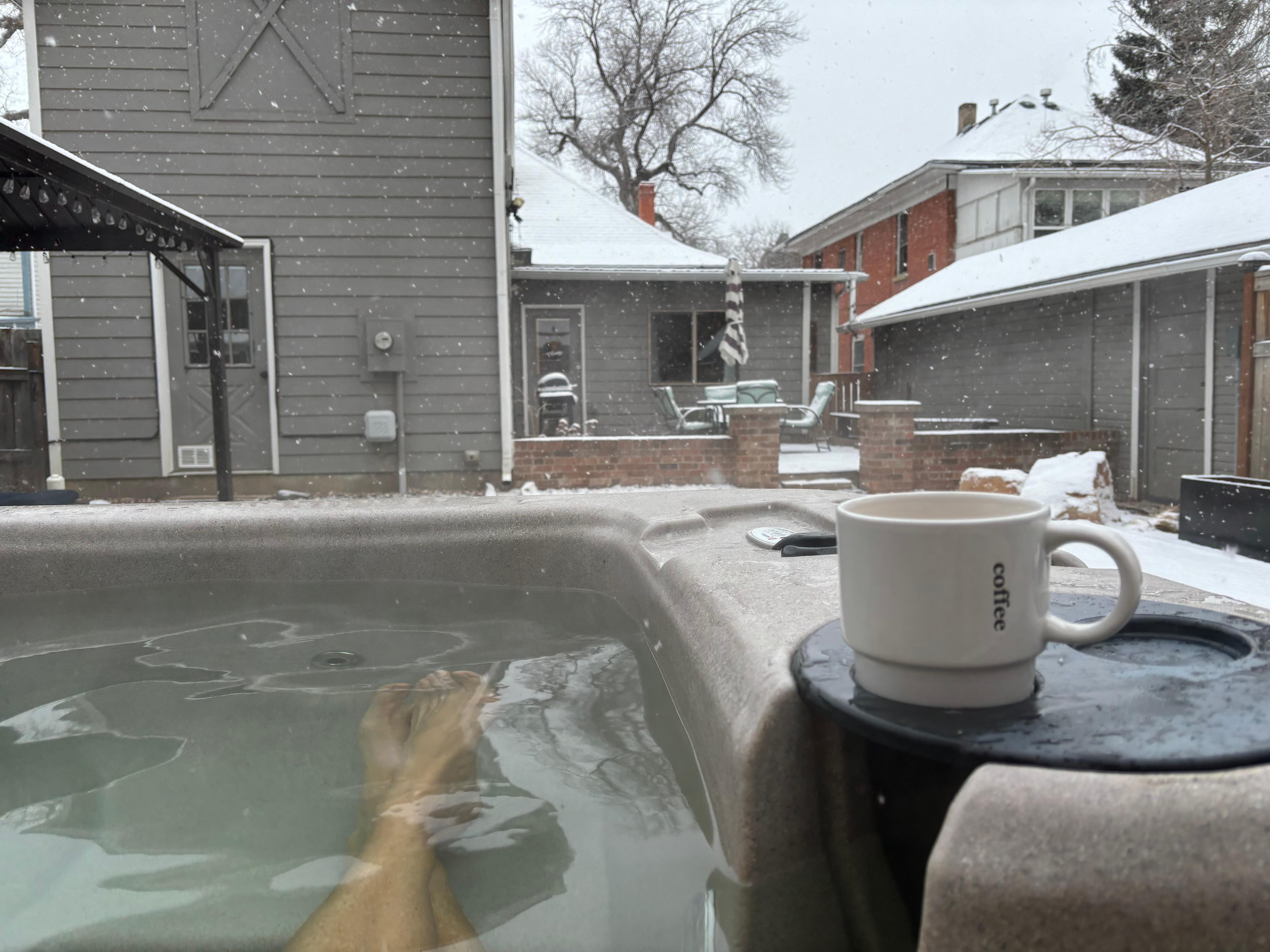 Coffee in the hot tub with snow falling. Perfect start to the day. 