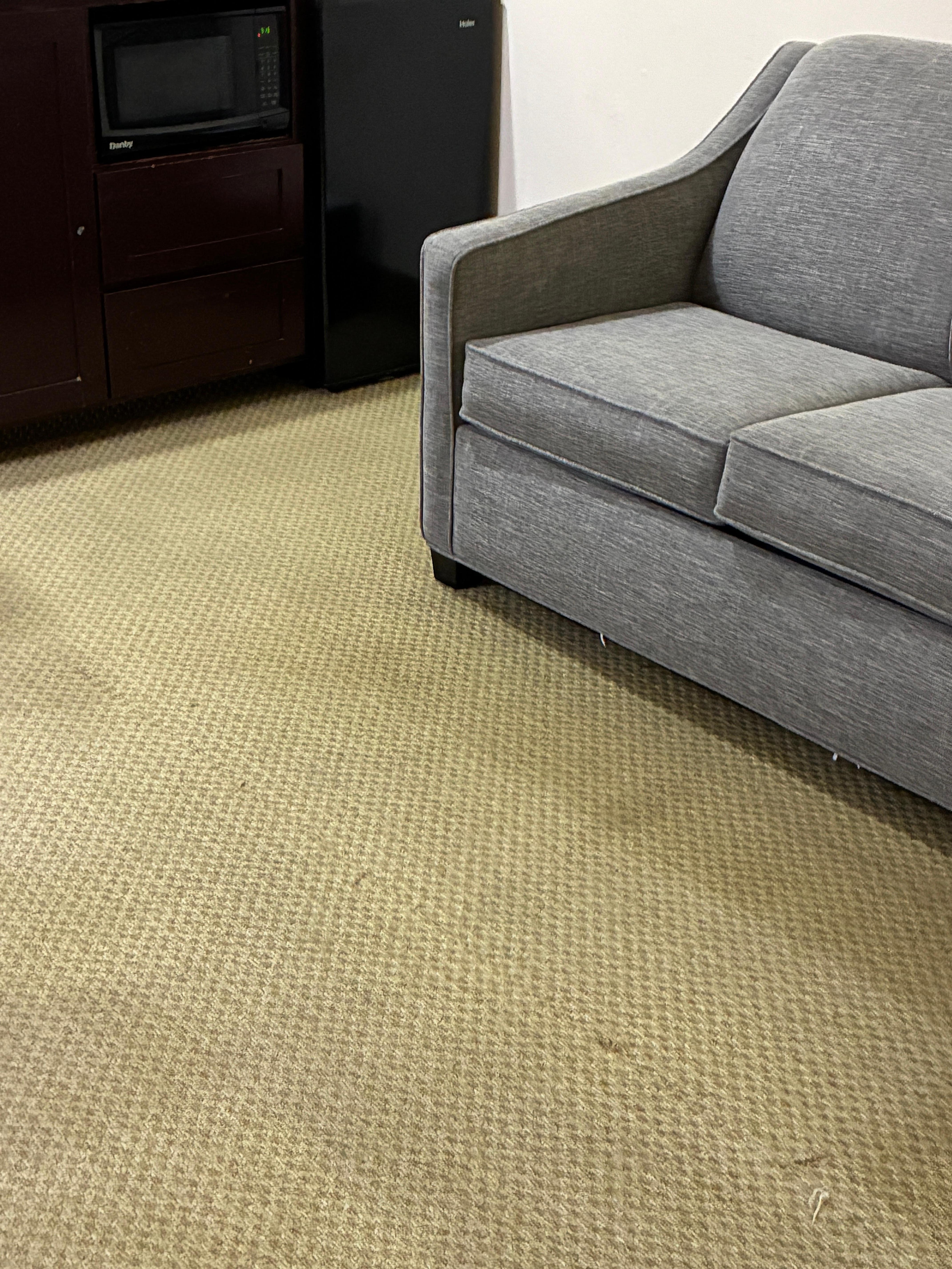 Worn out threads coming through on the carpet stained carpet