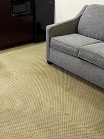 Worn out threads coming through on the carpet stained carpet