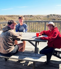 Grandsons enjoying the sunshine on the deck while eating