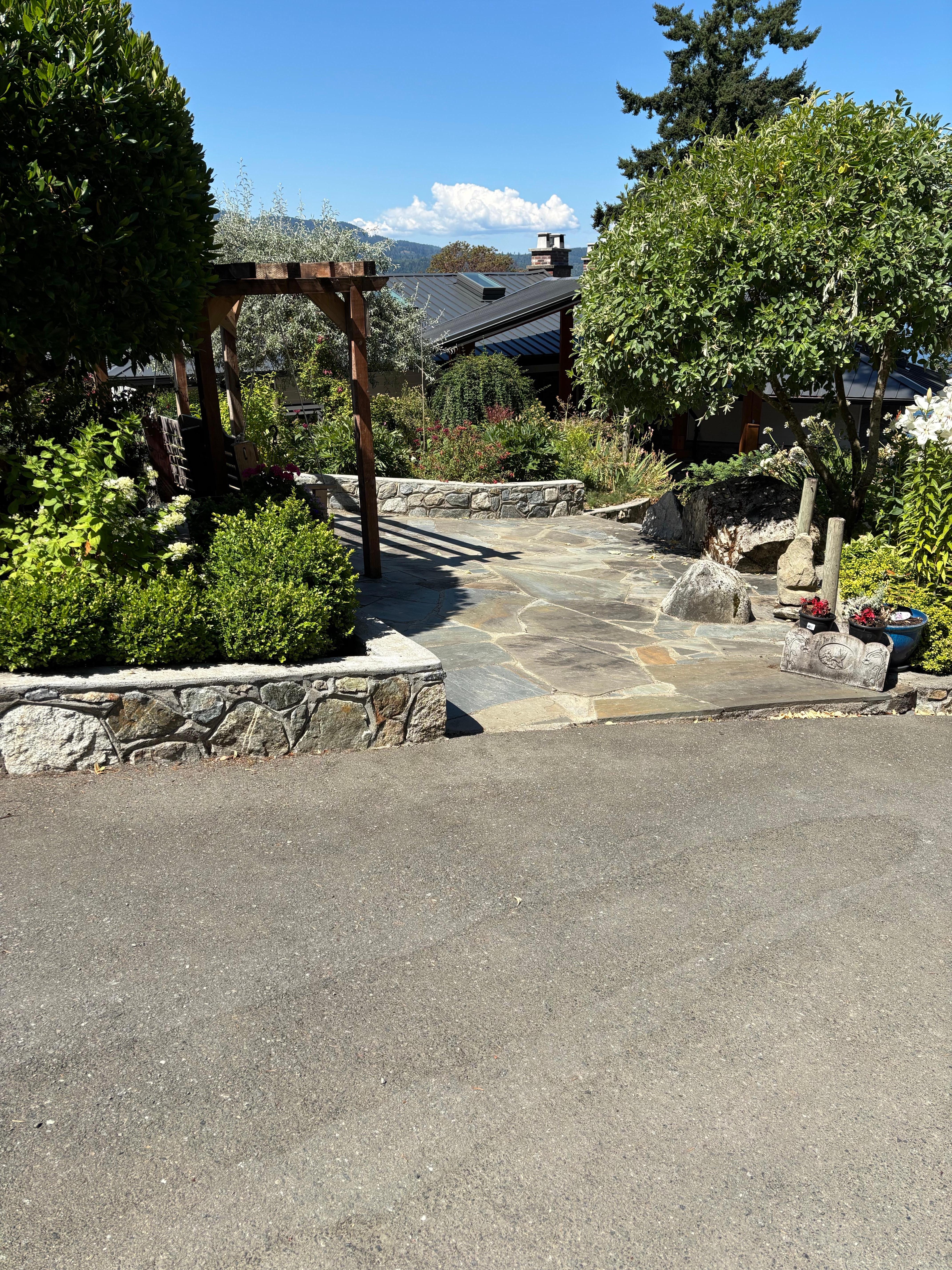 Across from the cottage, a beautiful garden with swing