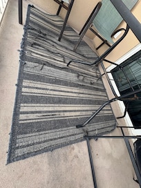Balcony rug is raveled  and disgusting