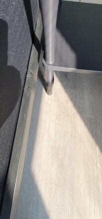Fluid stains and stuck hair on bedframe and floor in front of nightstand