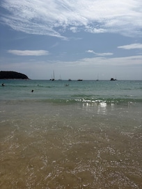 Clear water and gentle sloping beach at Nai Harn