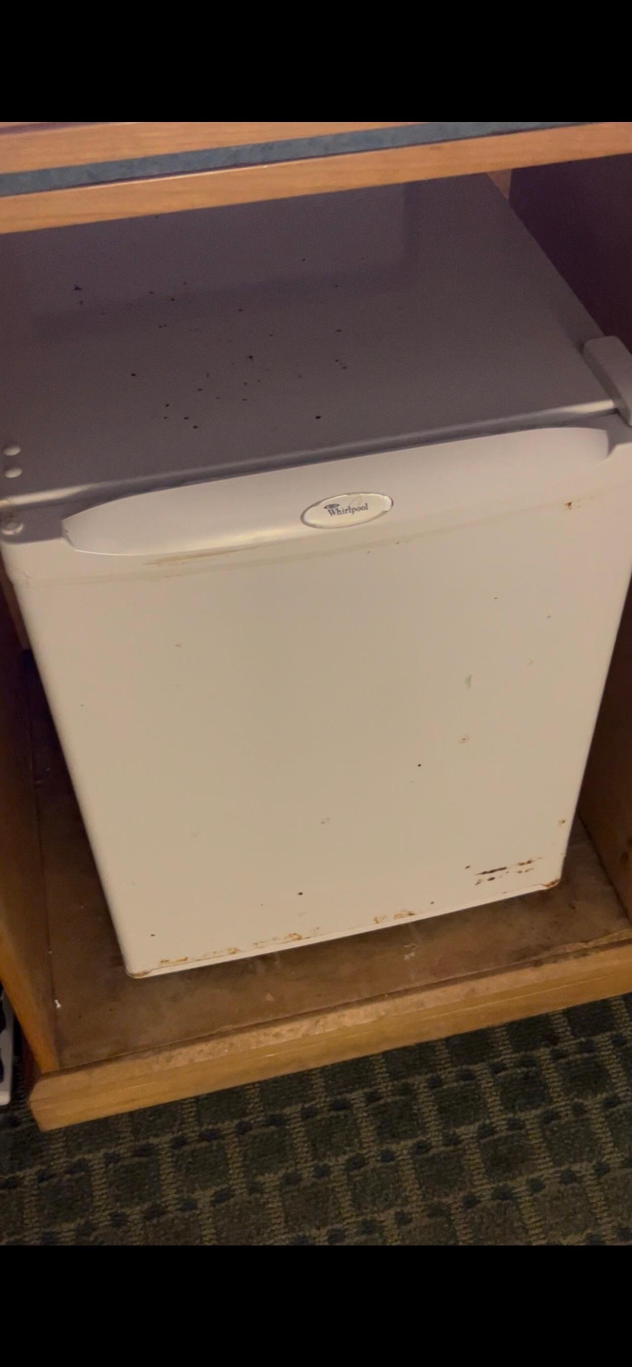 Refrigerator looked similar to the room door. It was rushed and very old looking.