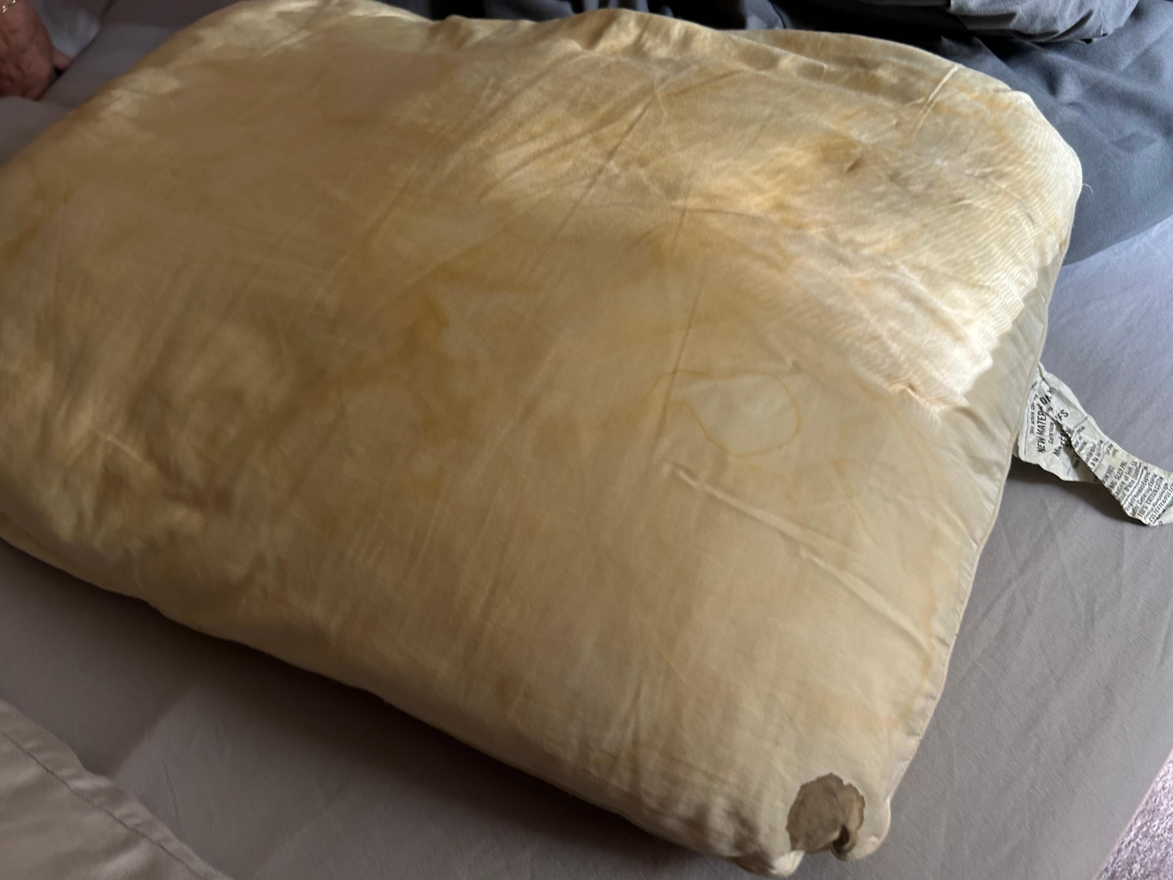 Disgustingly filthy pillow, stained with blood and sweat. 