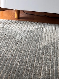 Broken glass and grime under tv cabinet