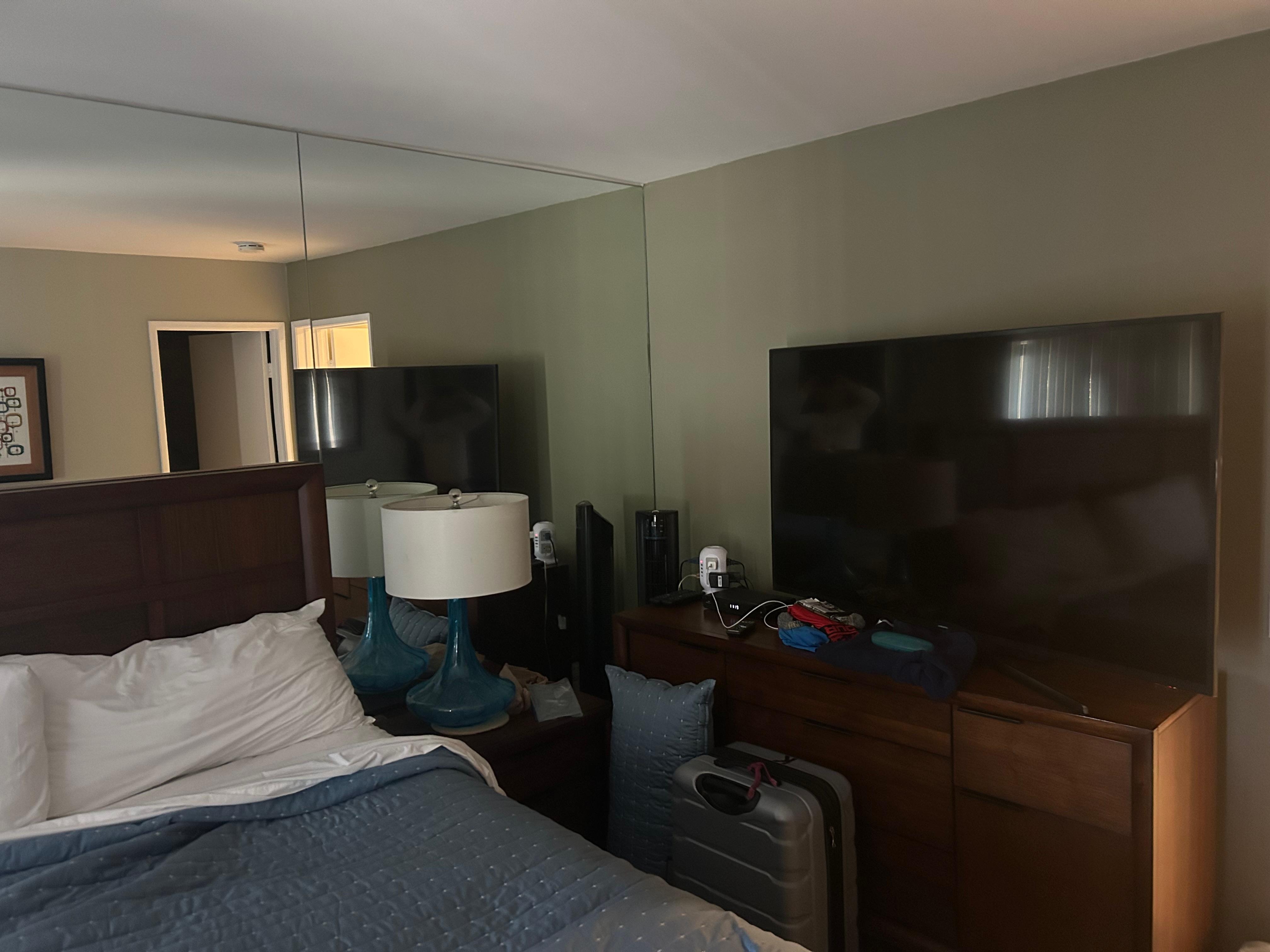 TV in bedroom was 60” next to bed. Living room a 32” with non functional remote