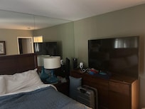 TV in bedroom was 60” next to bed. Living room a 32” with non functional remote