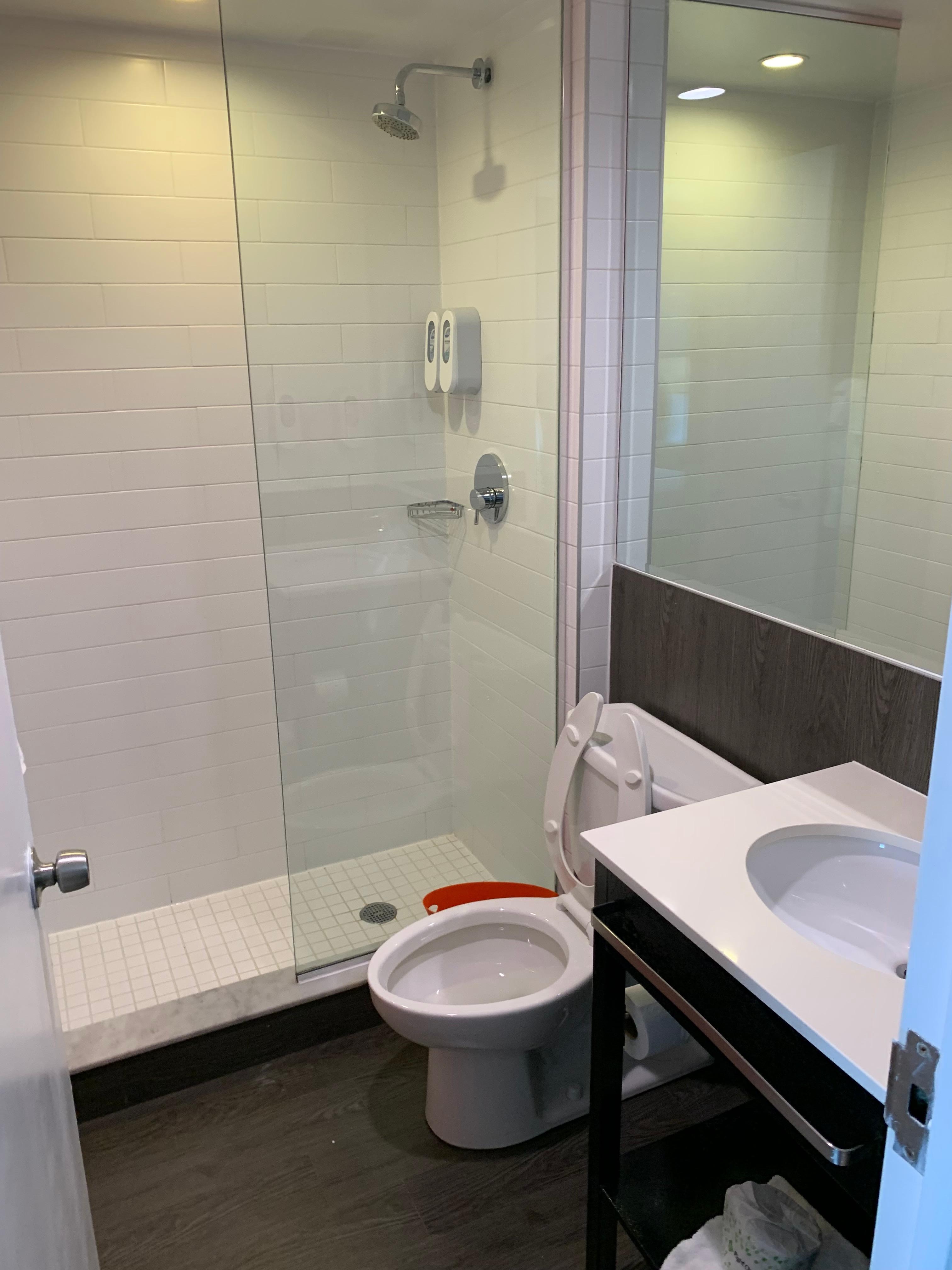 The part of the shower that is just open stays open as there is no sliding glass door or curtain.