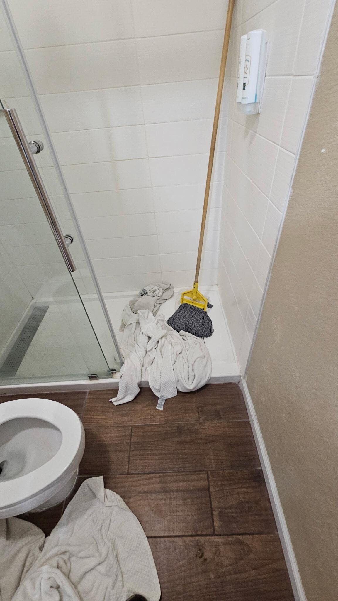 This is the mop and towels we used to clean up the floor the water went underneath the shower door on the floor into the other room