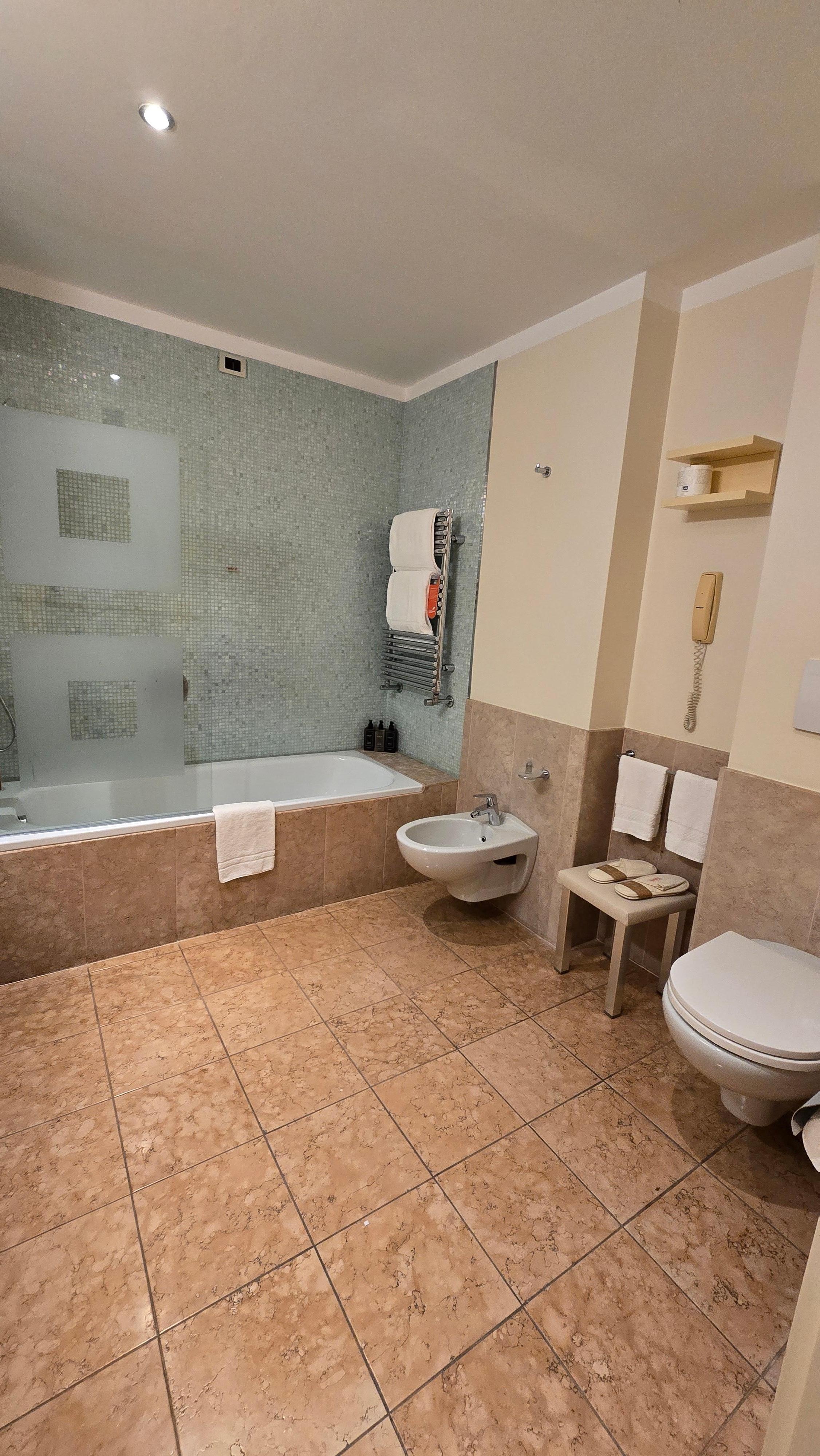 large bathroom with bathtub and bidet
