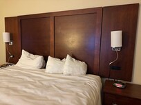 Headboard with dirty handprints and non-working reading lights