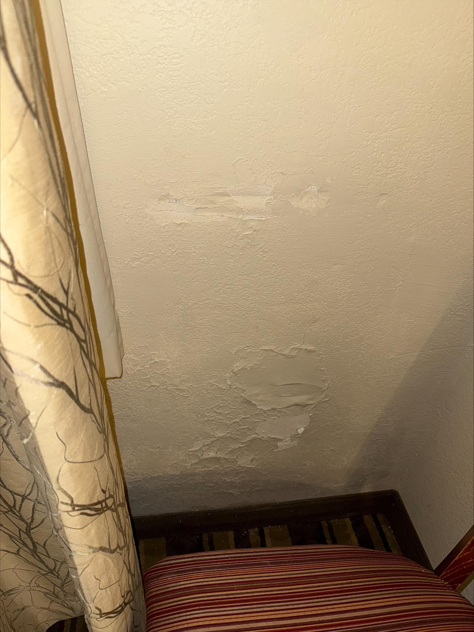 Terrible wall repair by the window.