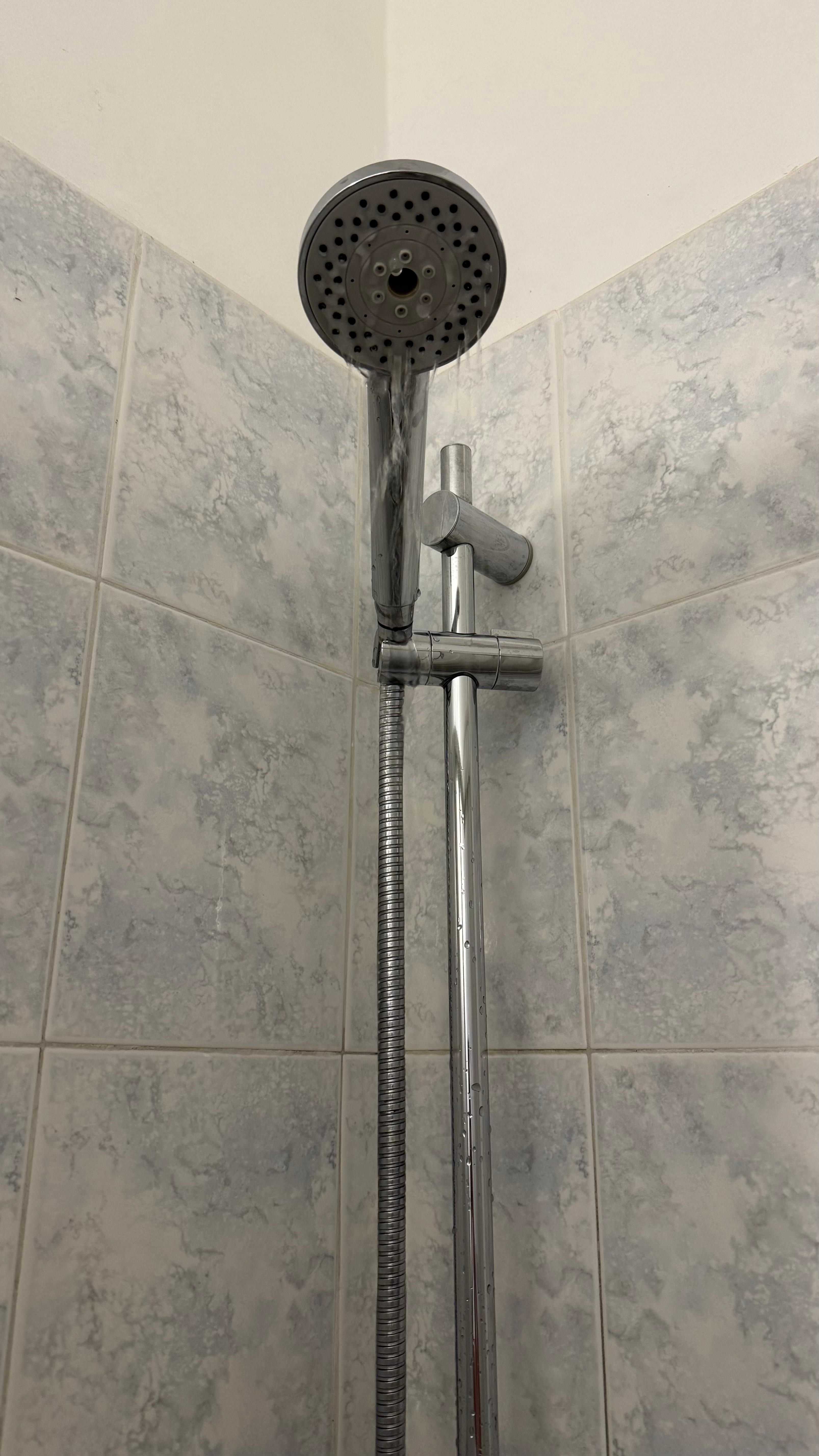 Dribbling shower with tap turned on fully