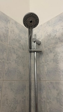 Dribbling shower with tap turned on fully