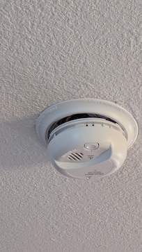 Fire alarm didn't look properly secured and unsure if functional