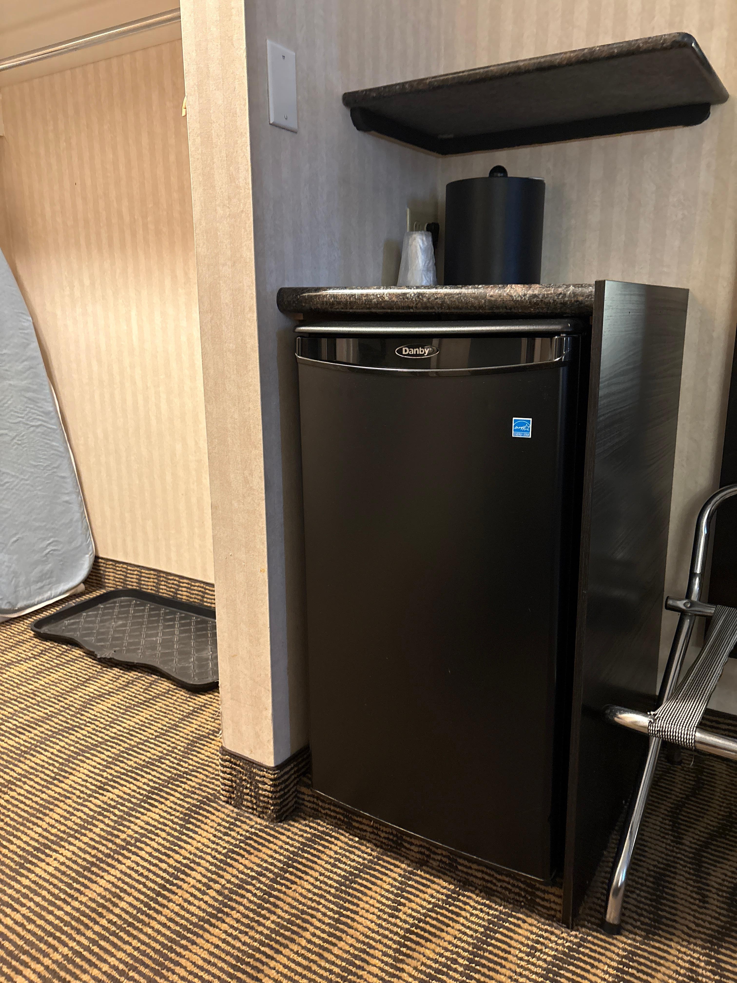 Mini fridge, luggage rack, iron and board, nice entry for shoes and coats. 