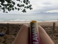Enjoying the waves near the tree.