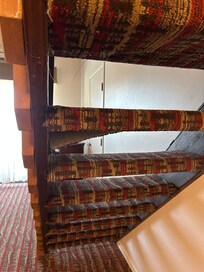 Torn and frayed carpet on stairs