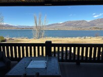 Lake view from deck - fire pit and comfy chairs.