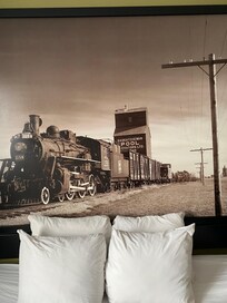 A Beautiful picture of a train in the room!