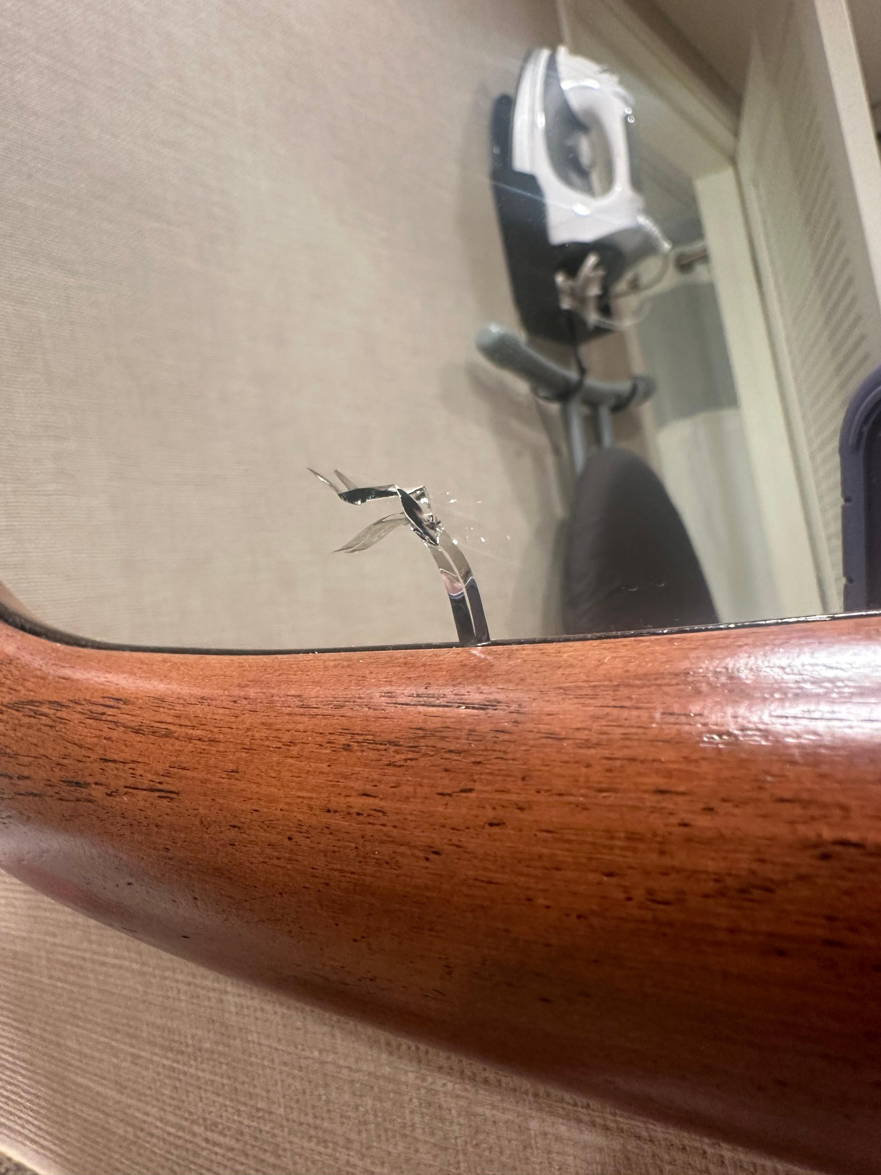 Crack in a mirror of the renovated room. 